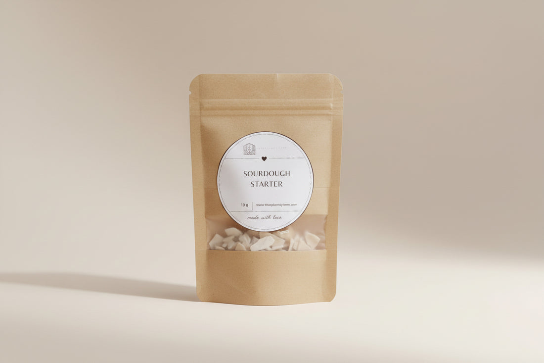 Kraft paper package with a label for sourdough starter on a wooden surface.