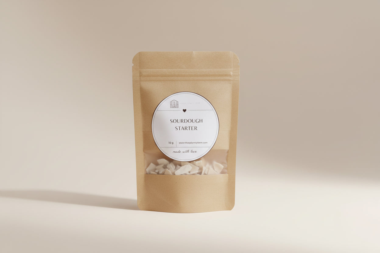 Kraft paper package with a label for sourdough starter on a wooden surface.